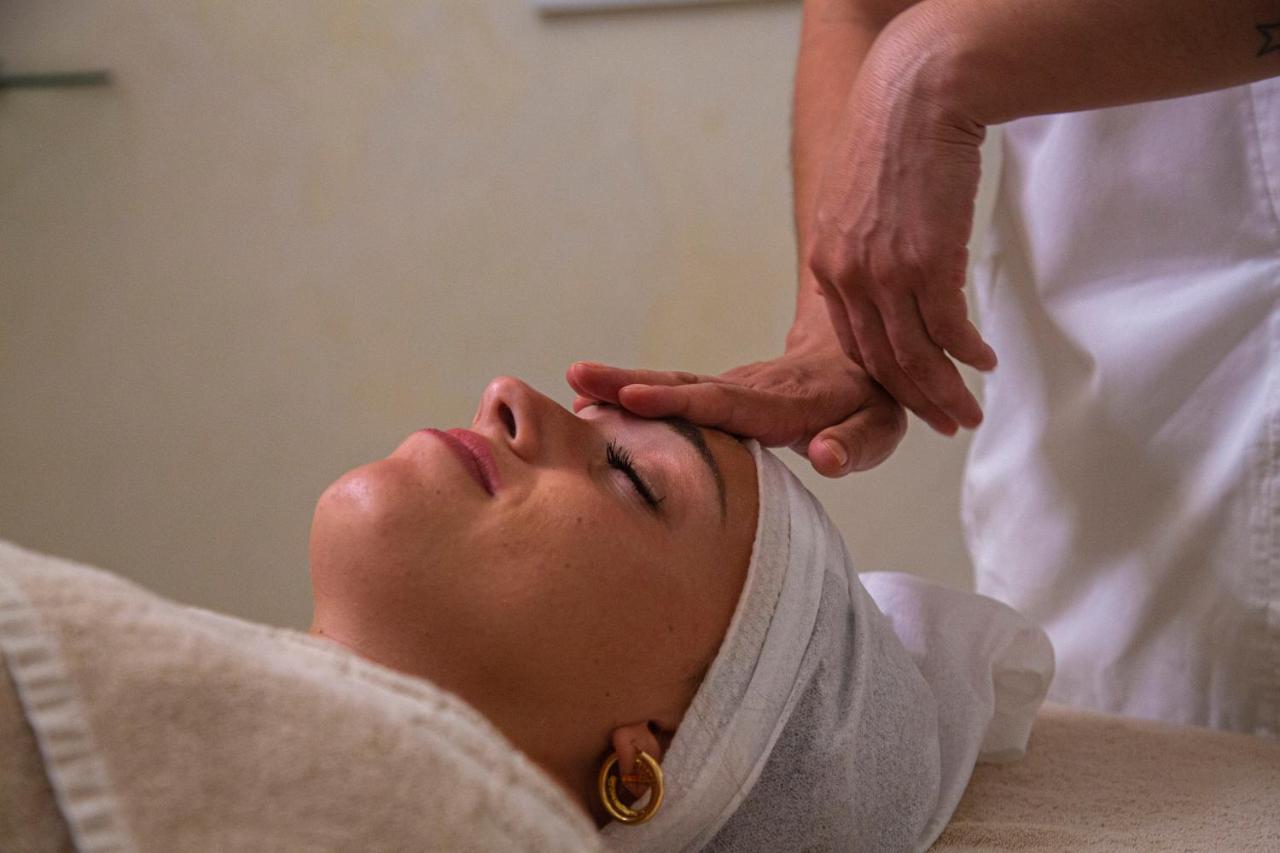 Golden Tower Hotel & Spa Florence Exterior photo A woman receiving a facial massage